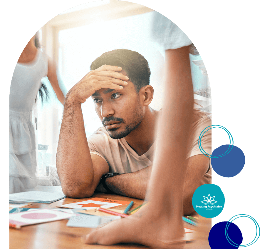 add counseling near altamonte springs, florida-1 Man looking stressed while sitting at a cluttered table, representing ADHD treatment in Altamonte Springs.
