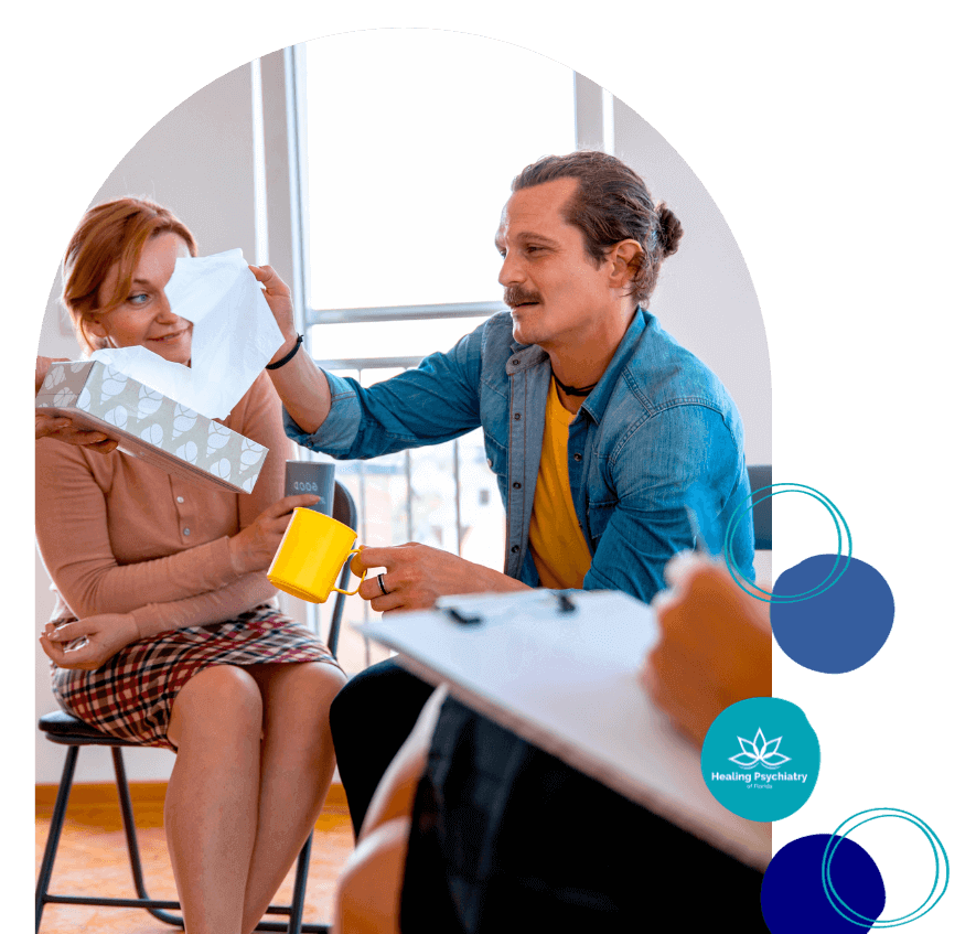 ocd treatment altamonte springs, florida A man offering a tissue to a woman holding a tissue box; logo for Healing Psychiatry. OCD treatment Altamonte Springs Living, Florida.