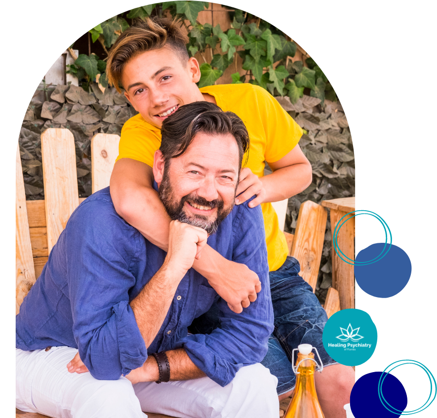 Father and teen son smiling, promoting teen therapy counseling in Altamonte Springs, Florida.