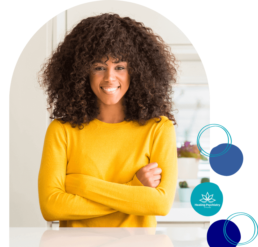 Smiling woman with curly hair wearing a yellow sweater, symbolizing success in bipolar disorder treatment in Altamonte Springs