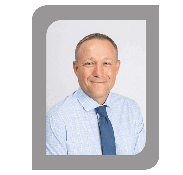 Headshot of Elvin Uhlenhopp, President and CEO, wearing a light blue shirt and tie