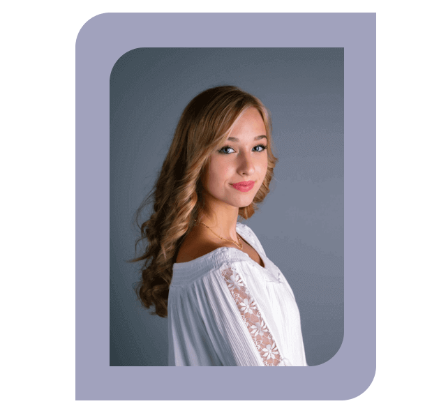 Headshot of Harmony Savasten, Administrative Assistant, wearing a white blouse with lace details