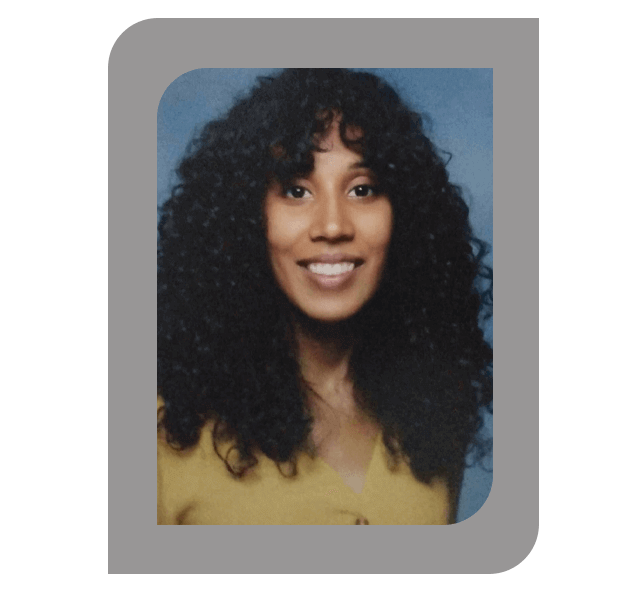 Headshot of Alexandra Batalla, LCSW, with curly hair, wearing a mustard-colored top