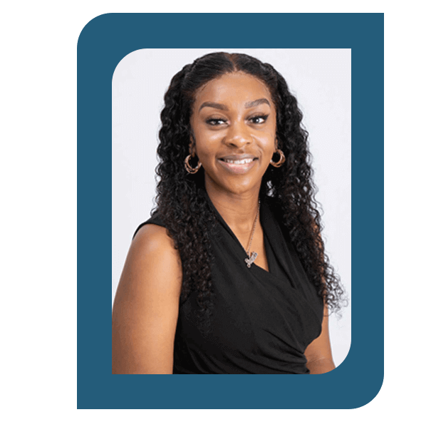 Headshot of Shauntis Woulard, Office Manager, wearing a black top and hoop earrings