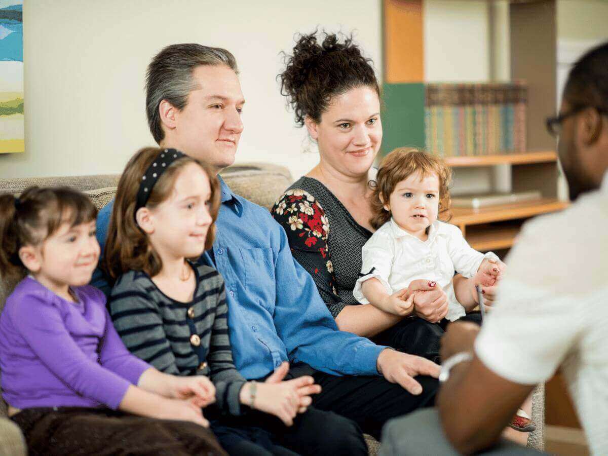 ADHD as an introvert blog banner showing a lonely girl sitting on a bridge looking out at the ocean