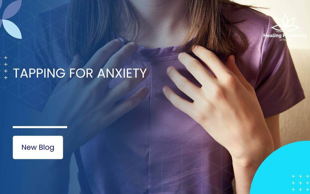 Close-up of a woman tapping her chest area with her fingers, demonstrating a technique for managing anxiety.