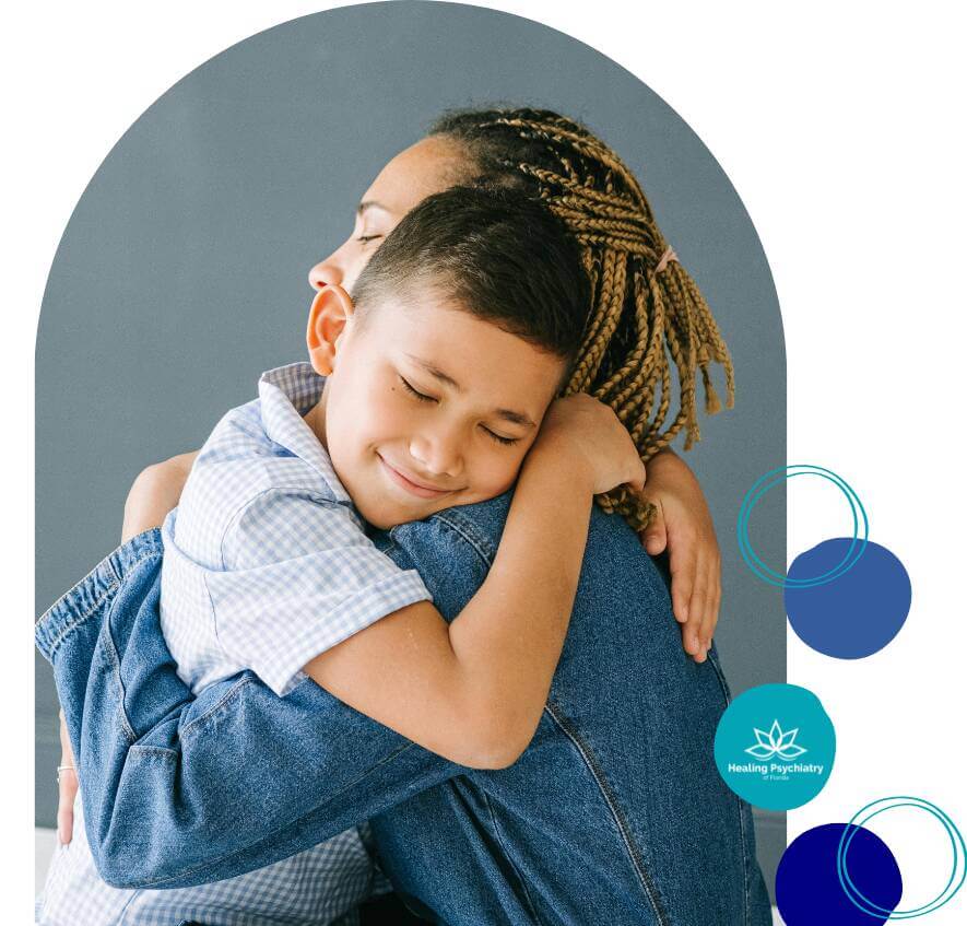 A young boy hugs his mother tightly, both showing calm and comfort during a heartfelt moment.